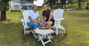 A woman and a young man sitting in white Adirondack chairs outdoors, with the text "Sip Your Way Around Burt Lake".